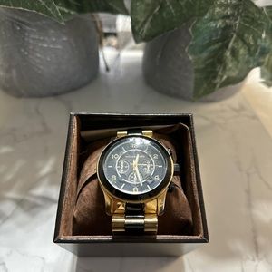 The iconic MK watch returns, updated with a two-tone bracelet strap.